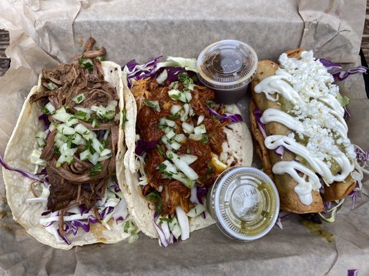 Tacos with barbacoa and cochinta pibil and taquitos with chorizo and barbacoa.