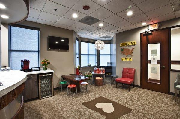 Play area with a tablet table, toys in the corner and refreshments for the adults.