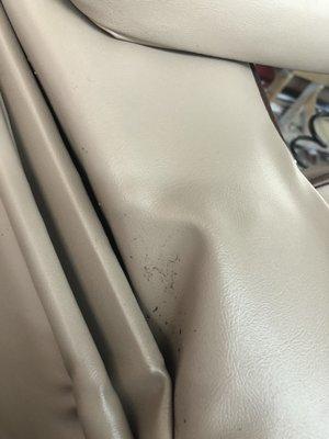 Loose fabric at rear bottom of seat