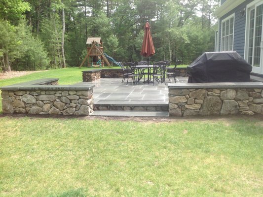 Large patio and stone wall