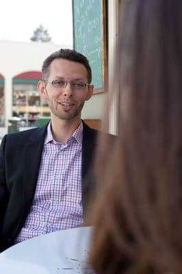 Ashley Murphy, CFP®, Founder/Principal talking to client at Elmwood Cafe, Berkeley, CA