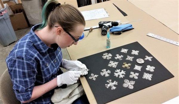 Katie polishing silver ornaments