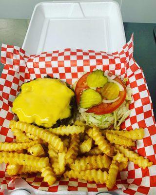 1/2 Lb Artisan burger with American cheese, lettuce, tomato, onion, and pickles and fries.