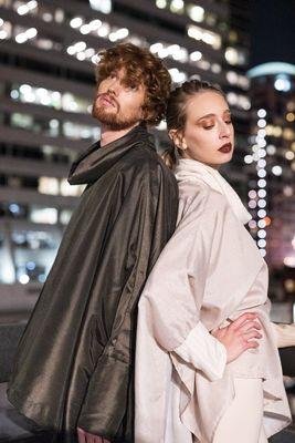 two fashion models pose back to back on a rooftop in Portland Oregon