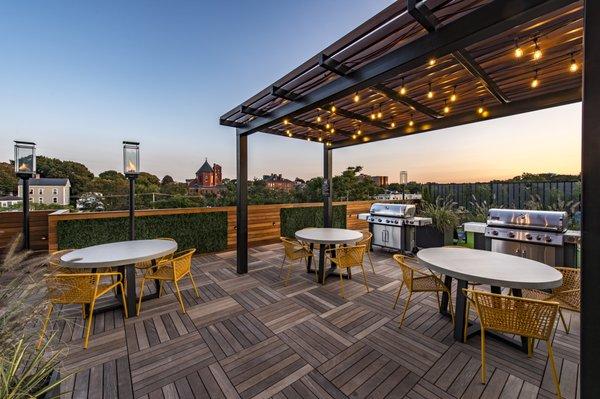 Rooftop deck with ample seating, two grilling stations and cornhole game.