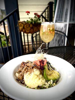 sushi grade Ahi Tuna Bowl with Avocado, mango rice, passionfruit ponzu, & cucumber salad. Accompanied by White Sangria Spritz