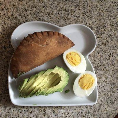 Take-home. Breakfast beef empanada with avocado and hard boiled egg.