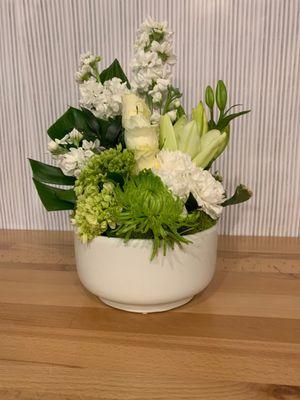 White Bowl Design of Lilies Roses and Stock.  Beautiful