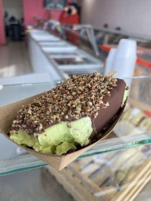 Pistachio dipped in milk chocolate with pecans topping