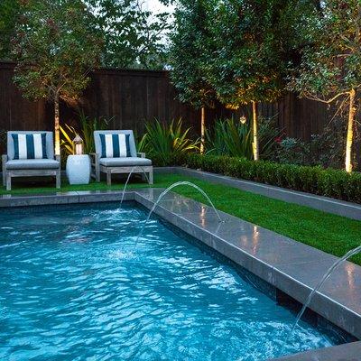 Residential pool with deck jets and landscaping