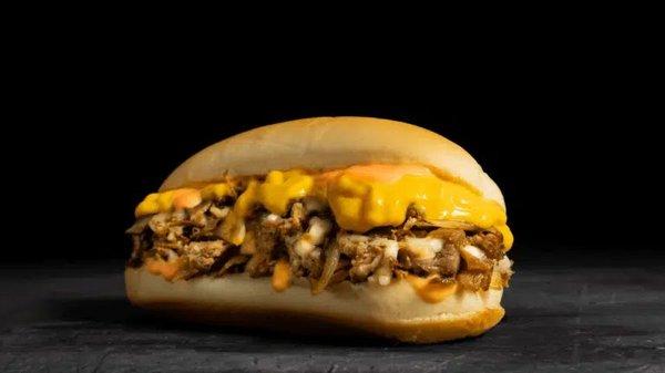 Chipotle Cheesesteak: Thinly sliced steak, melted provolone, cheddar sauce, griddled onions, chipotle sauce on a toasted hoagie roll