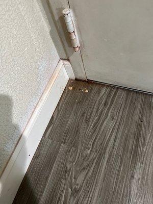 Floor behind door.