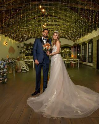 Bridal gown in champaign, skin, and white color, with over skirt/train attached.