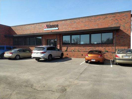 The front entrance and parking lot in front of our offices