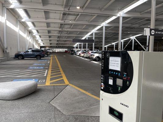 Charging stations are along the left side, follow the yellow sidewalk