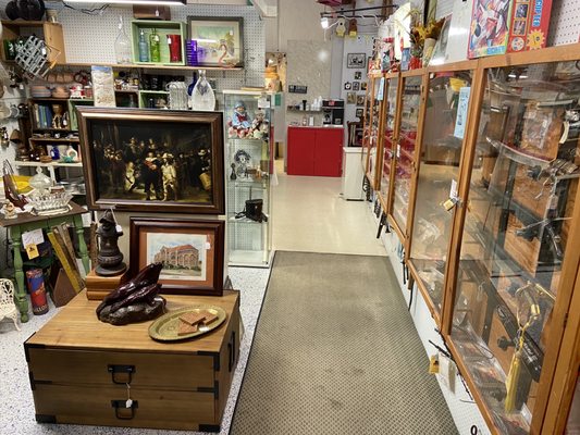 A booth with a bit of historical. A selection of antique swords, paintings, statues, etc.