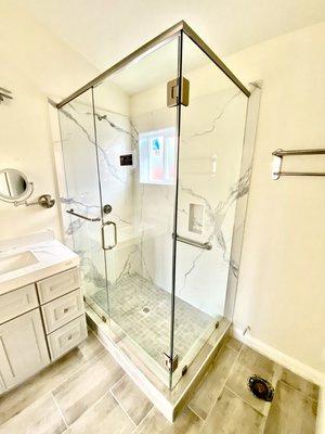 Frameless shower door with header. A more convenient design for an ADU unit.