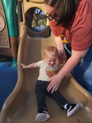 Happy Grandson going down a slide.