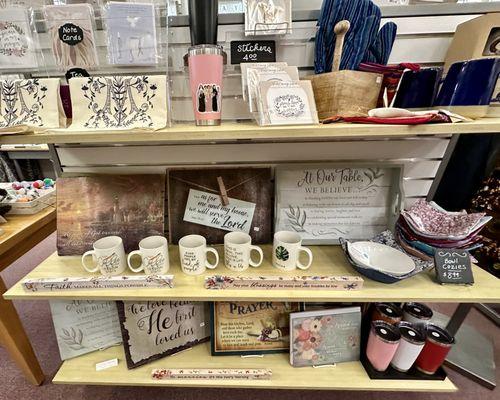 Shelves of Christian decor, cups, etc.