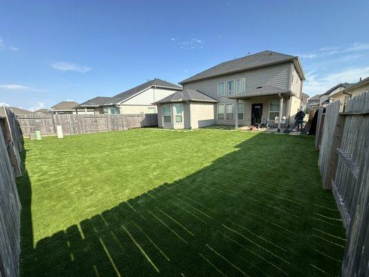 New synthetic turf installation for backyard. Now their kids can enjoy playing soccer without the issue of mud all over the yard!