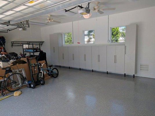 Garage cabinets designed around existing windows.