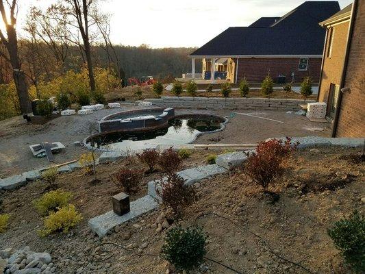 Complete landscape install with Natural stone walls and limestone steps backyard, irrigation and lighting.