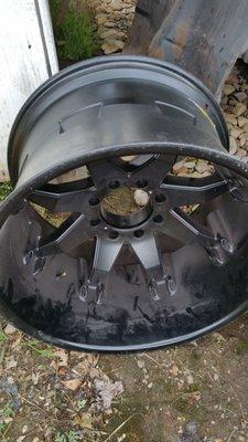 WHEEL BROUGHT IN TO STRIP/REMOVE THE POWDER COATING.  (BEFORE)