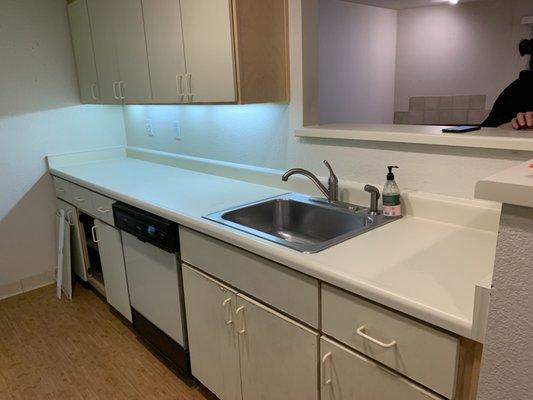 Before remodel - old kitchen cabinets, dishwasher, sink, faucet, counter top.