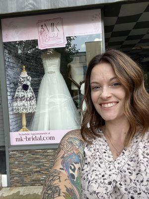 Owner of MK Bridal, Mackenzie, in front of new storefront windows