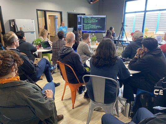 Attendees listen to a speaker at a Techlahoma meetup at Clevyr HQ