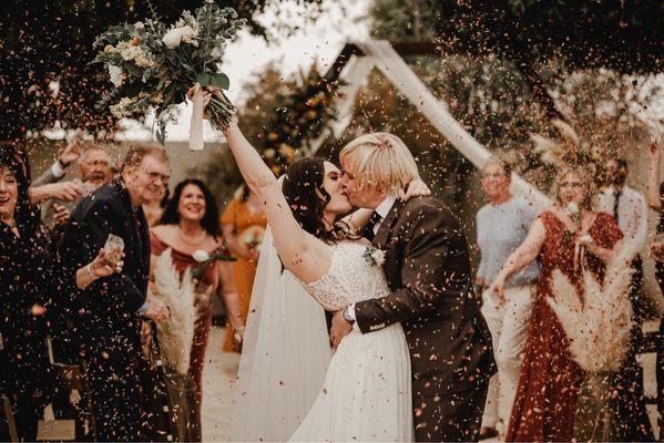 Rose petal toss send off of bride and groom