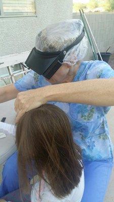 LiceDoctors tech Lori uses all-natural lice treatment on her client.