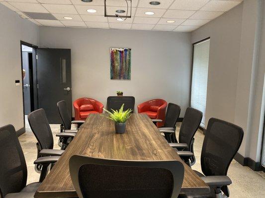 The conference room can easily sit 8 at the table with another 16 around the room.  Complete with Magnetic white board and projection TV