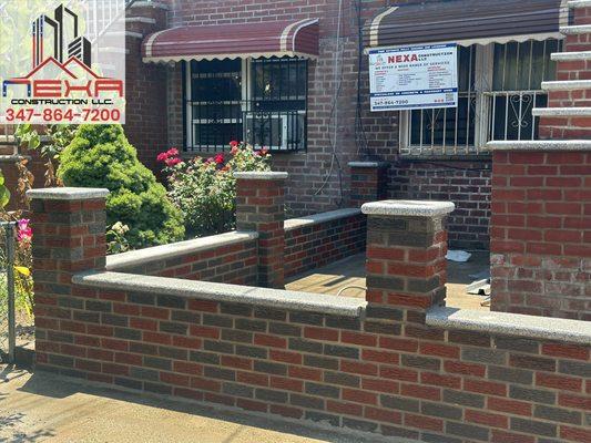 A complete view of beautifully blended mixed brick fence and steps.