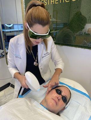 Nurse Christy using one of our restorative laser technologies.