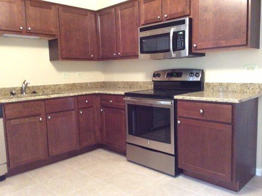 Wood Cabinets, Granite Counter-tops and Stainless Steel Cabinets in Remodeled Apartments