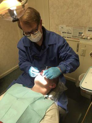 Owner Dr. John G. Robertson Working On A Patient