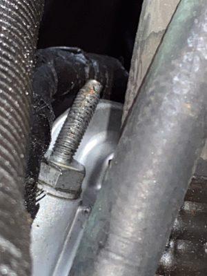 One of several bent studs on front of engine