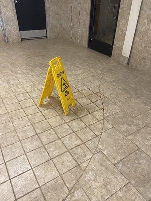 Wet floor sign over some type of stain