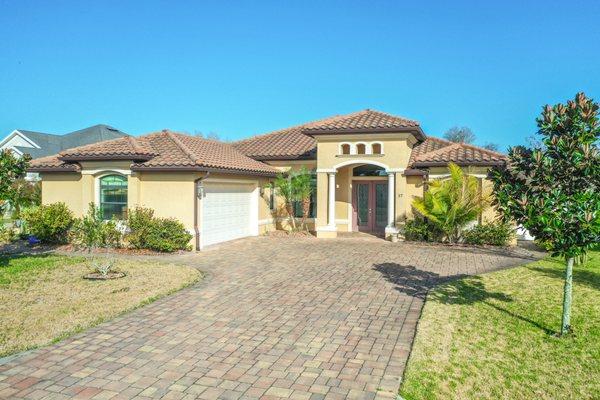 Beautiful Mediterranean  style home complete with a tile roof and a luxuious paver driveway!