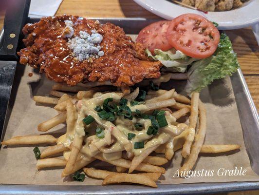 The Big Dixie, a chicken fried chicken breast in Buffalo Sauce with Bleu cheese crumbles and Lettuce and tomato and beer cheese fries.