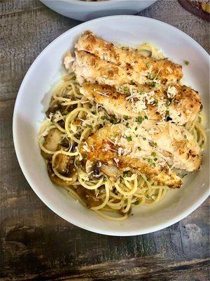 Lemon Chicken Piccata, topped over a garlic mushroom tossed pasta.