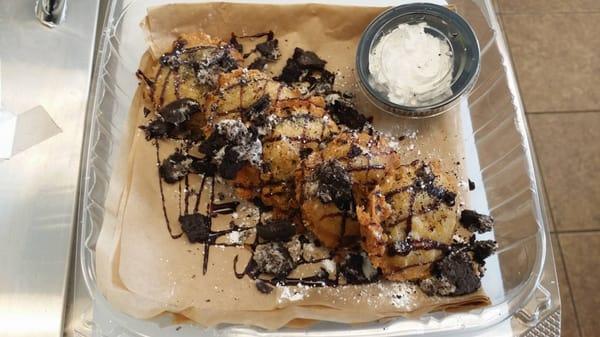 Deep Fried Oreos Served drizzled with chocolate sauce and crumbled Oreo pieces and whipped cream for dipping!