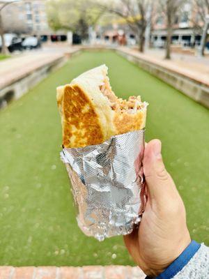 Enjoying a burrito at the park