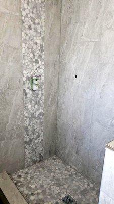 Tile waterfall using pebble tile.