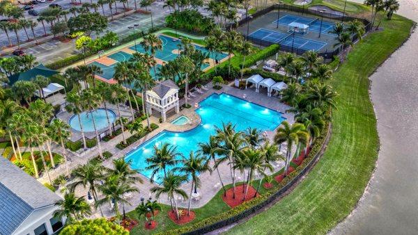 Madison Green Club house drone overview  of the outside amenities - community pools,  hot tub, tennis and basket ball courts.