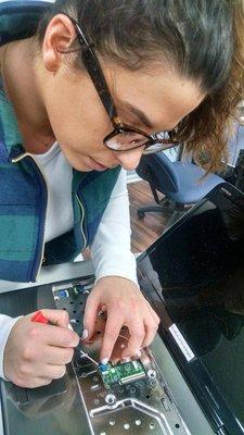 Kristen, our Forensic Technican working on a Forensic case removing a hard drive.