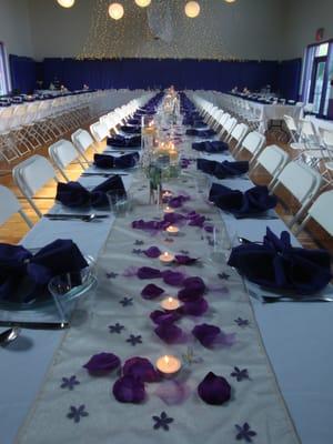 Banquet style seating at a purple hydrangea themed wedding.