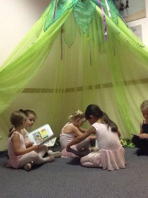 A class reads a fairy tale before the Fairy Ballerina Camp.