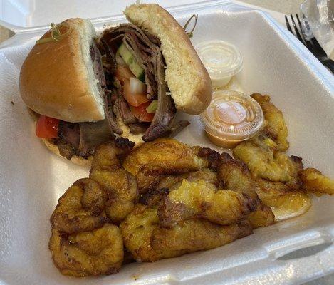 BEEF SUYA SANDWICH $13: Potato Bun, Smoked Beef, Tomato, Bell Peppers, Onion, Edie's dressing. dodo. Notice pool of grease on plantains